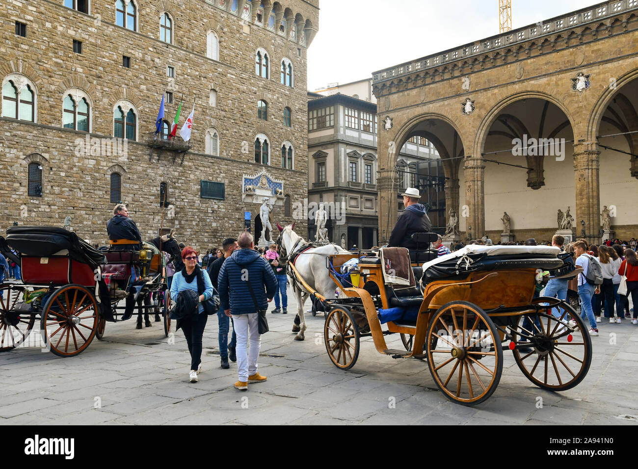 Horse drawn carriages in front of Palazzo Vecchio in Piazza della Signoria, Unesco World Heritage Site, in the centre of Florence, Tuscany, Italy Stock Photo