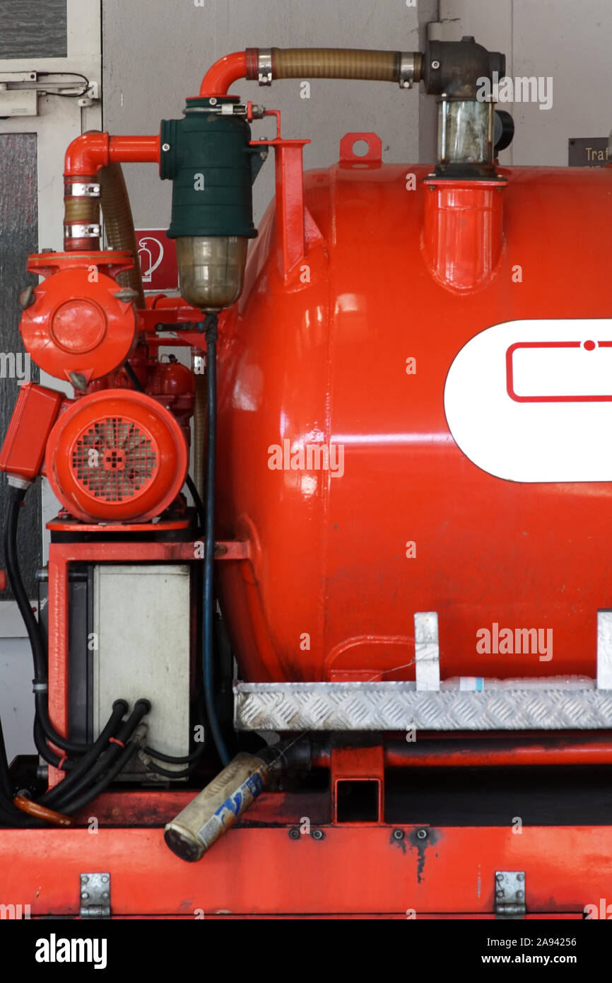 The close-up of the red body and water tank of a fire truck or small fire truck. Stock Photo