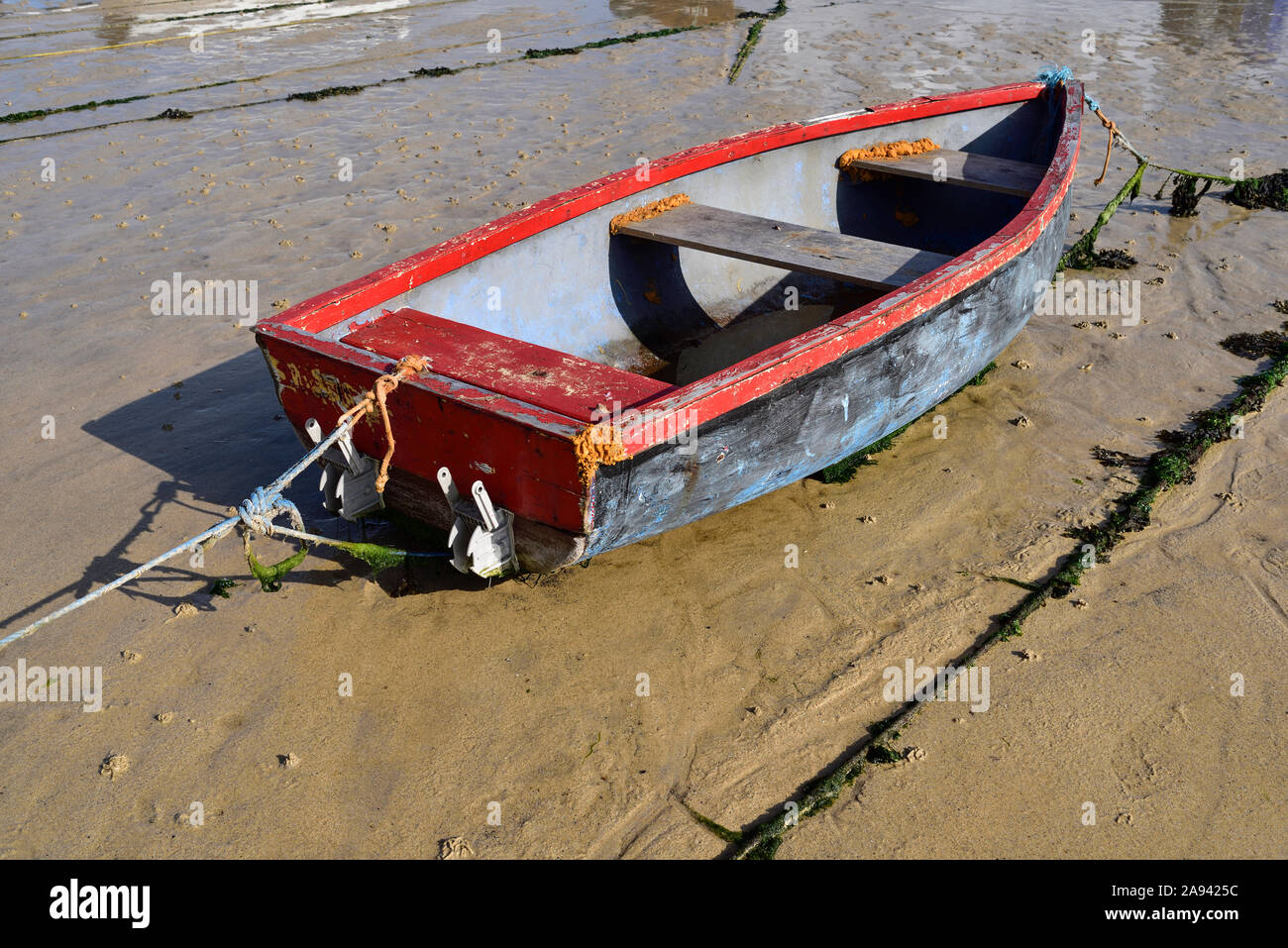 Rowing boat moored at low tide on the beach at St Ives, Cornwall, in the summer. Stock Photo