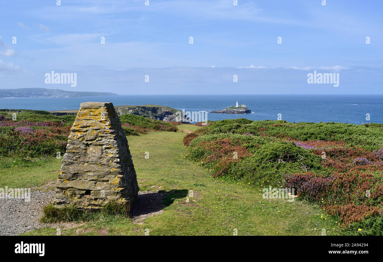 The south west coast path in Cornwall between Navax Point and Portreath. In the distance is Godrevy Lighthouse on its island. Stock Photo