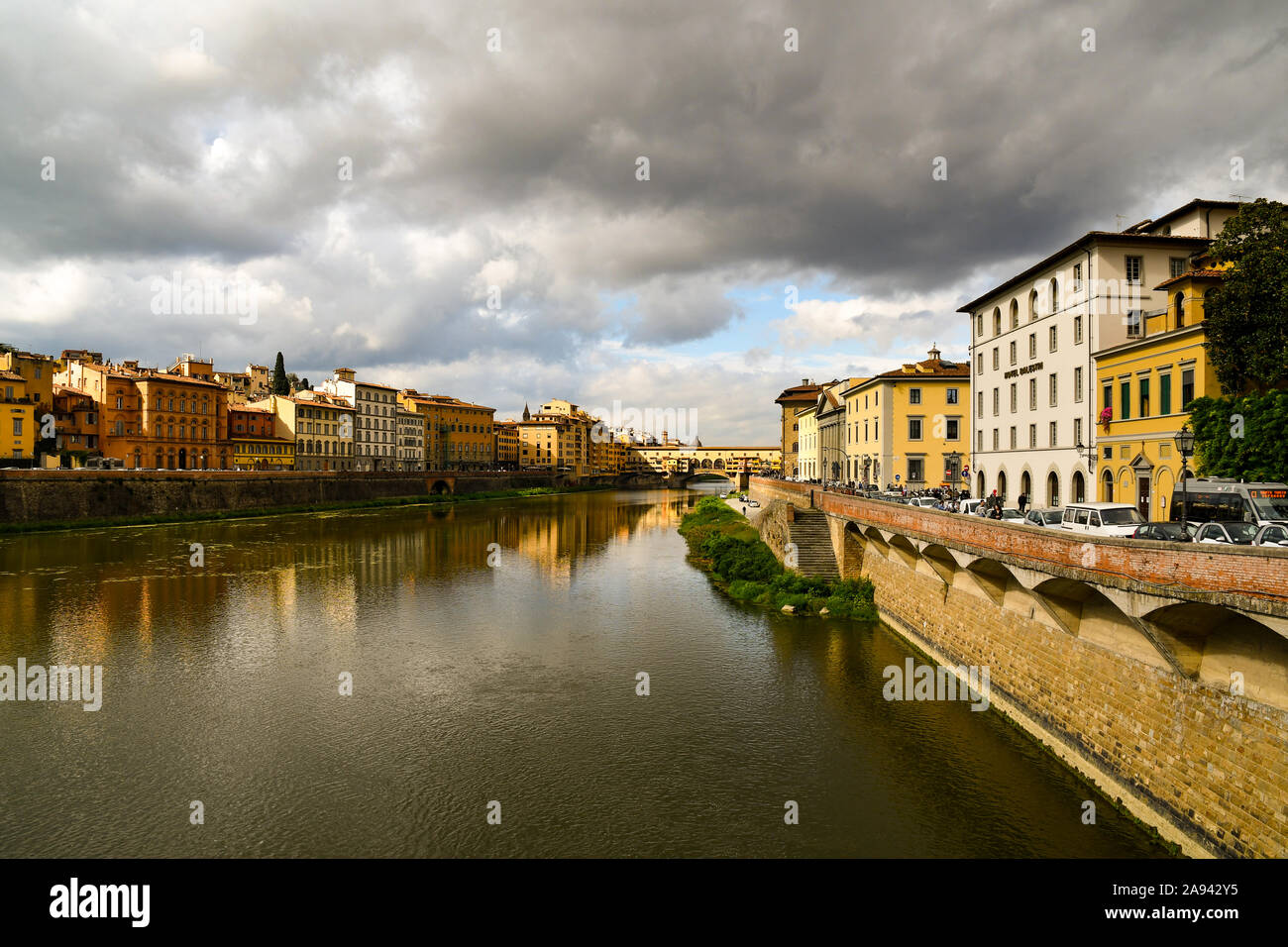 Scenic view of Lungarni with the famous Ponte Vecchio medieval bridge and stormy sky in autumn, Unesco World Heritage Site, Florence, Tuscany, Italy Stock Photo