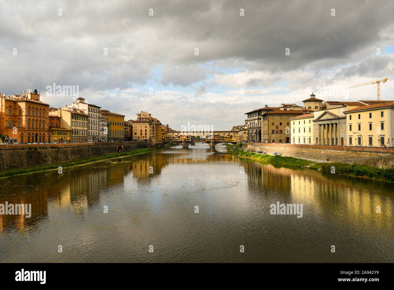 Scenic view of Lungarni with the famous Ponte Vecchio medieval bridge and stormy sky in autumn, Unesco World Heritage Site, Florence, Tuscany, Italy Stock Photo