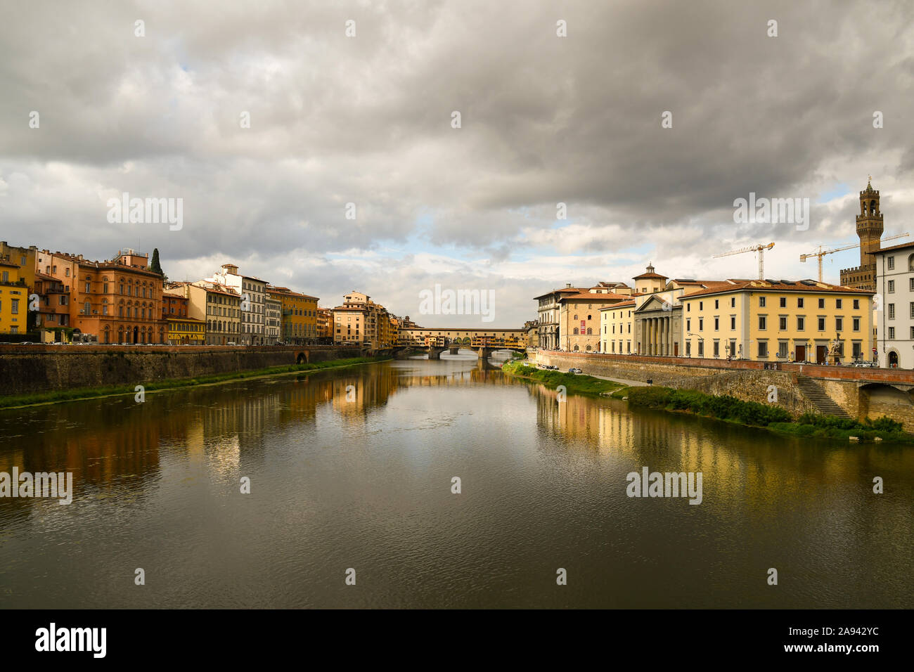 Scenic view of Lungarni with the famous Ponte Vecchio medieval bridge and stormy sky in autumn, Unesco World Heritage Site, Florence, Tuscany, Italy Stock Photo