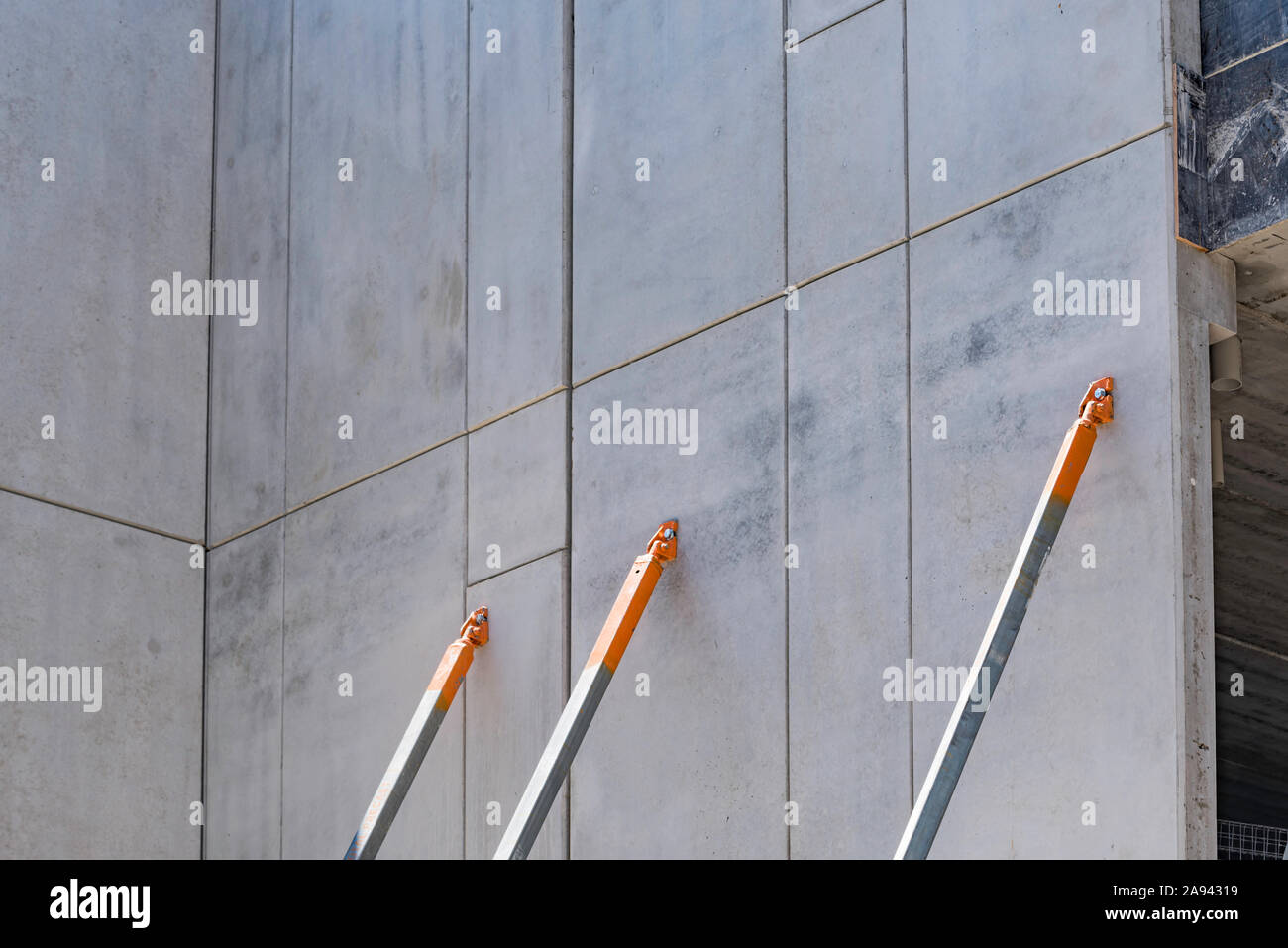 Tilt-up, tilt-wall or tilt-slab walls supported with braces or rods made from steel or alloy on a construction site in Sydney, Australia Stock Photo