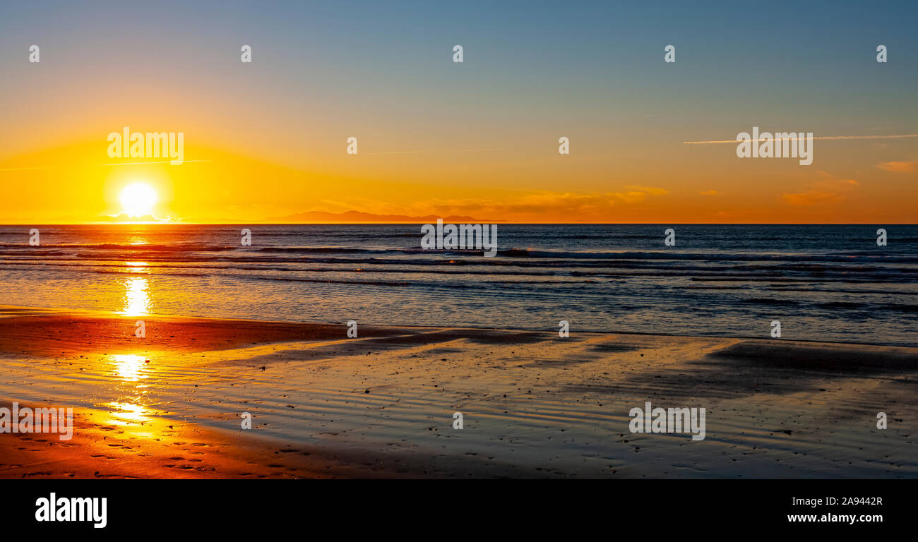 Bright sunset over the ocean off the North shore of New Zealand; North Island, New Zealand Stock Photo
