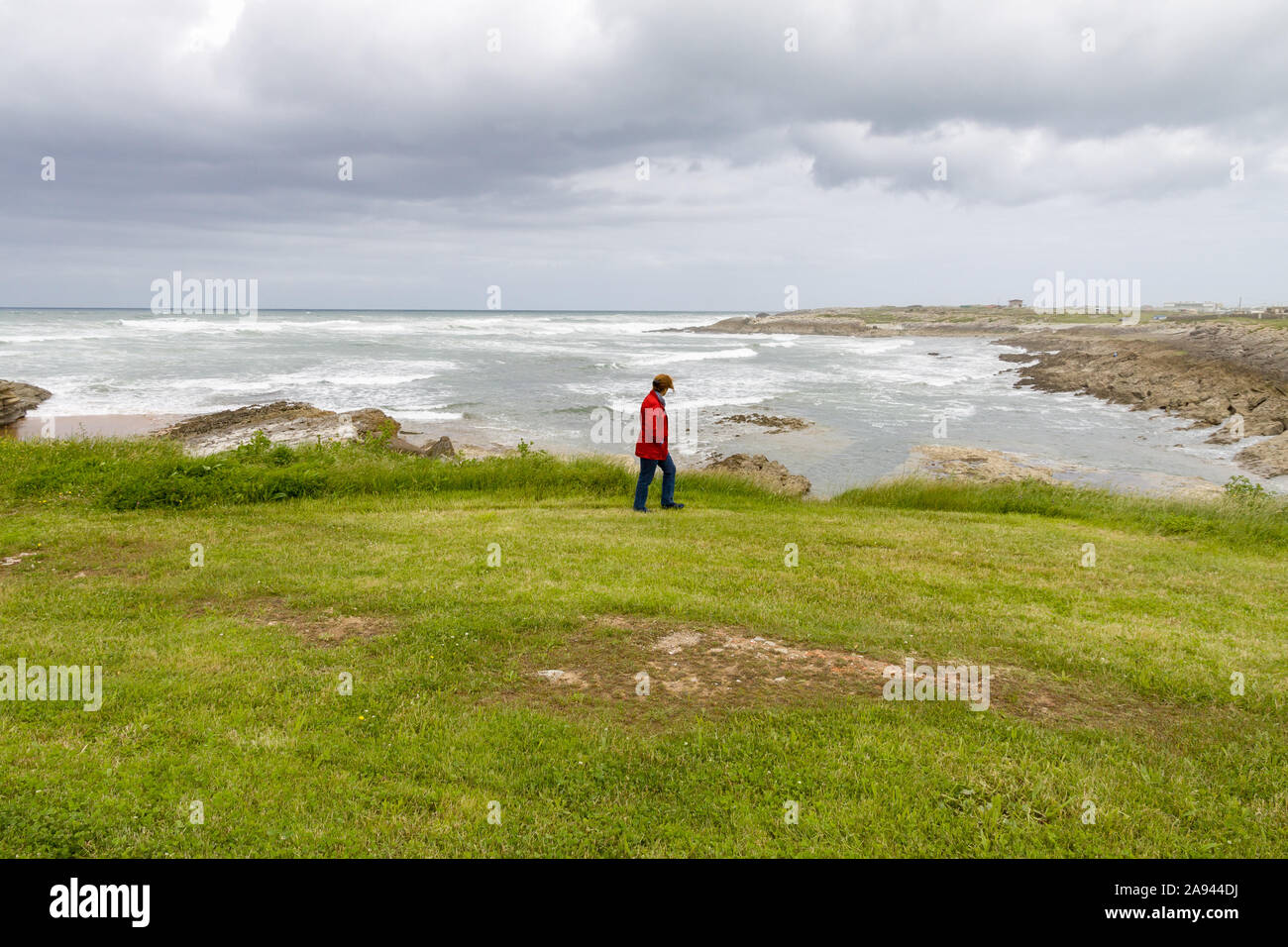Person watching the sea in winter in the north of Spain Stock Photo