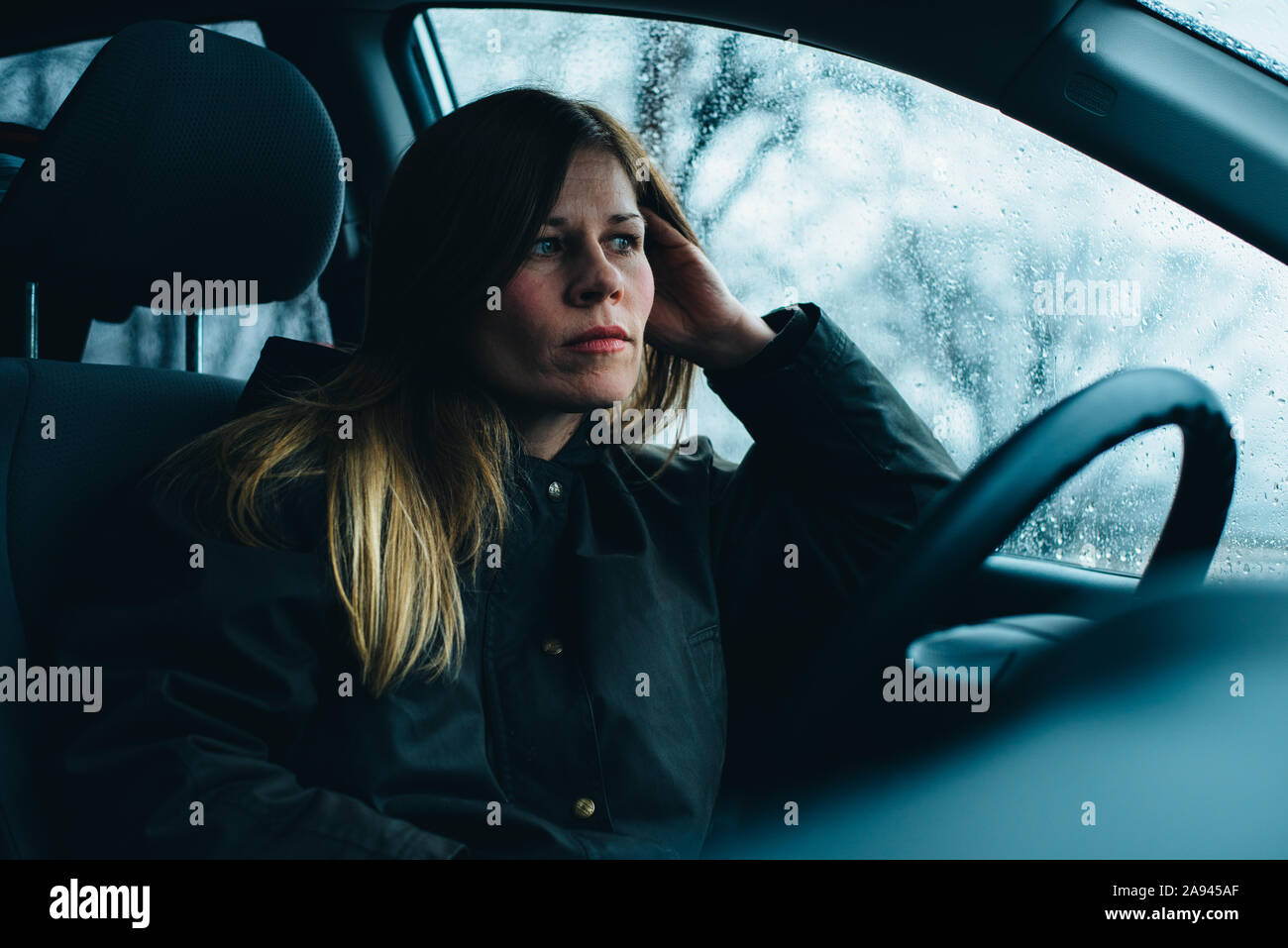 A woman sits in a car. Stock Photo