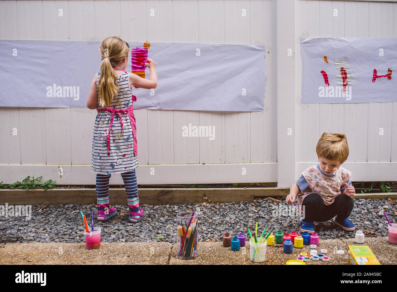 Two children paint outside. Stock Photo