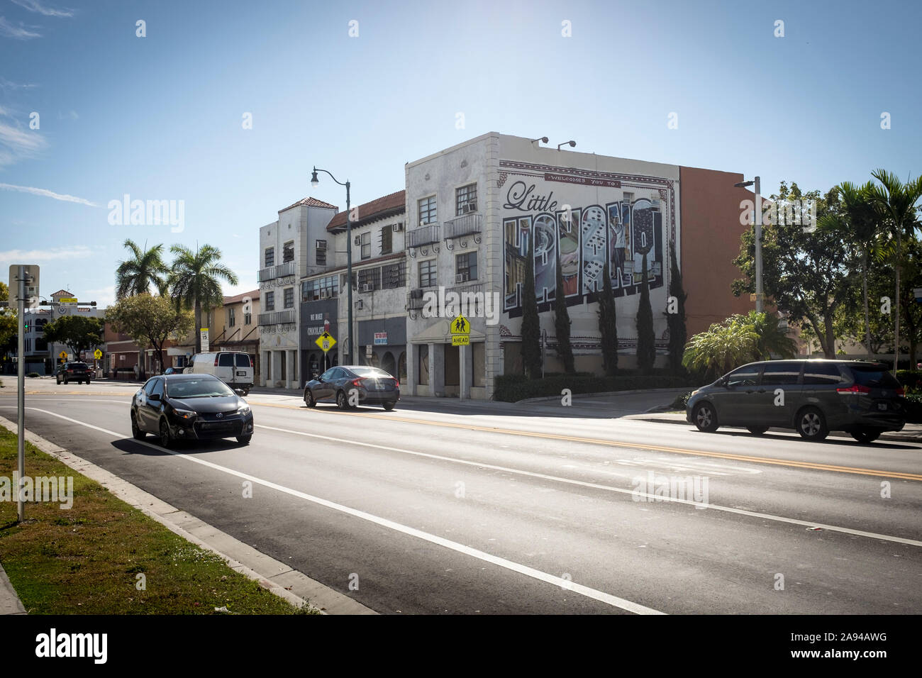 Cars drive by a building with Little Havana painted on the side on SW 8th Street, or Calle Ocho, in Miami, Florida Stock Photo