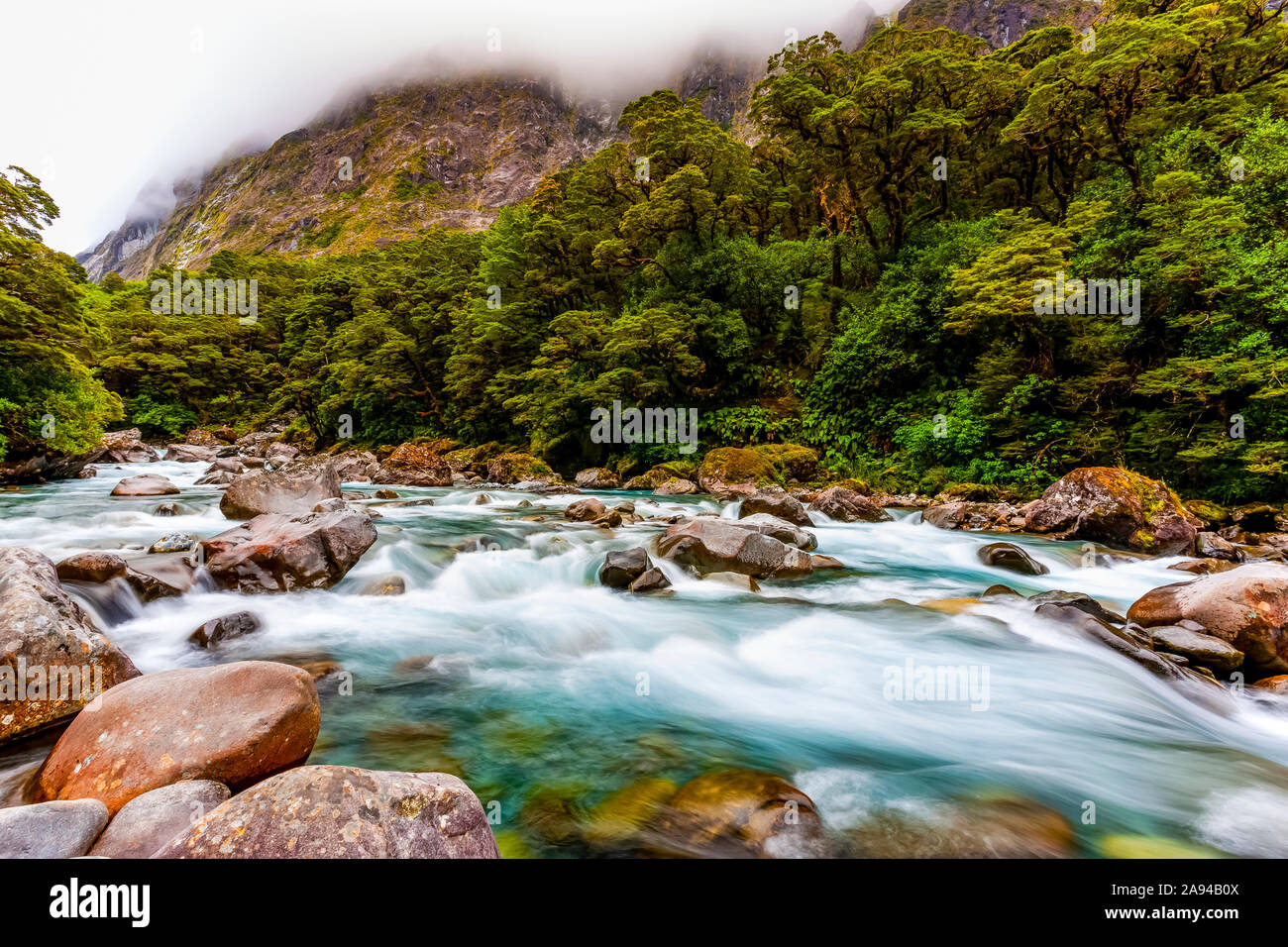 A river under low cloud; South Island, New Zealand Stock Photo