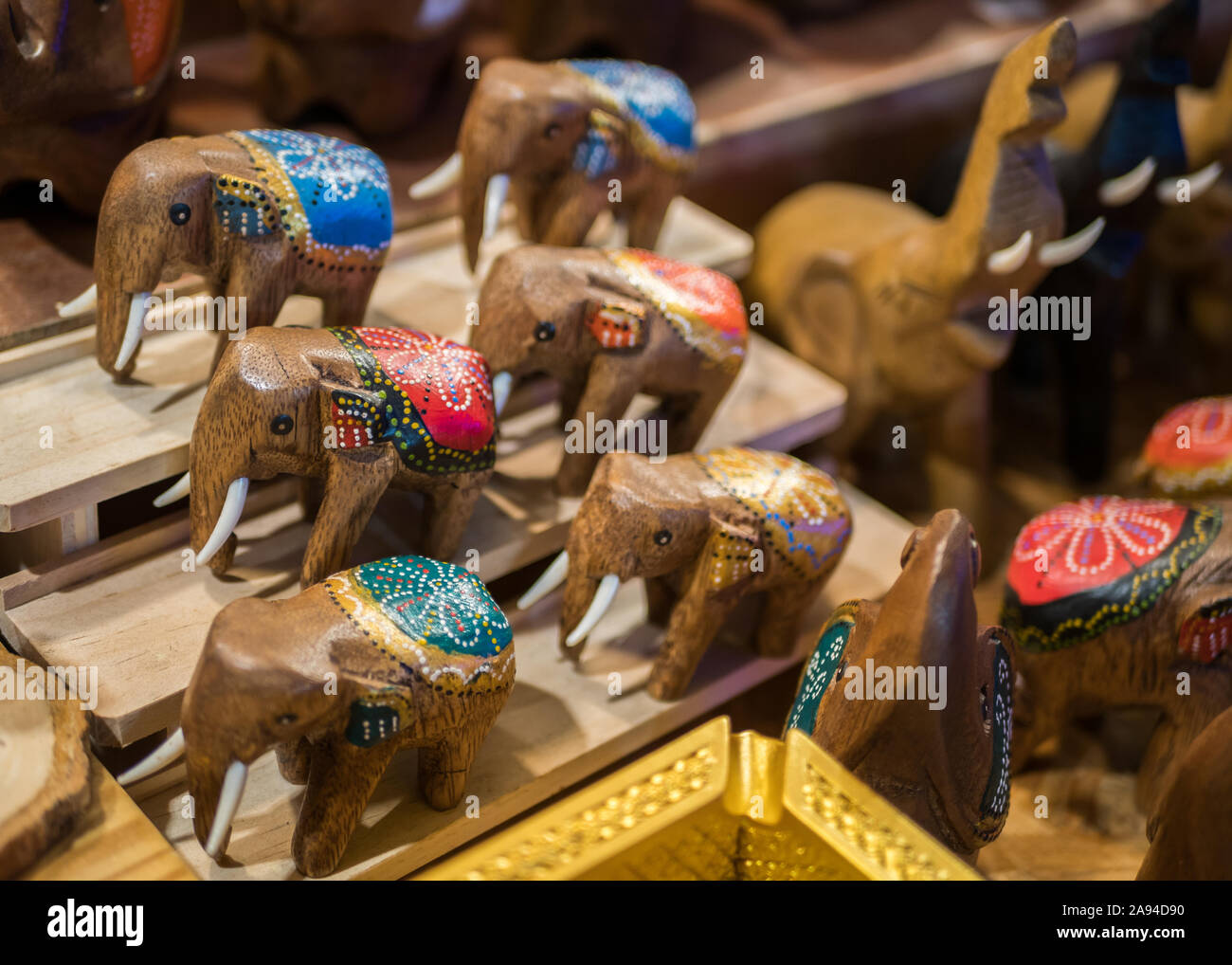 Close-up view of the carved wooden elephants selling in the souvenirs stall at Ratchada Rot Fai Train Night Market Bangkok,Thailand. Stock Photo