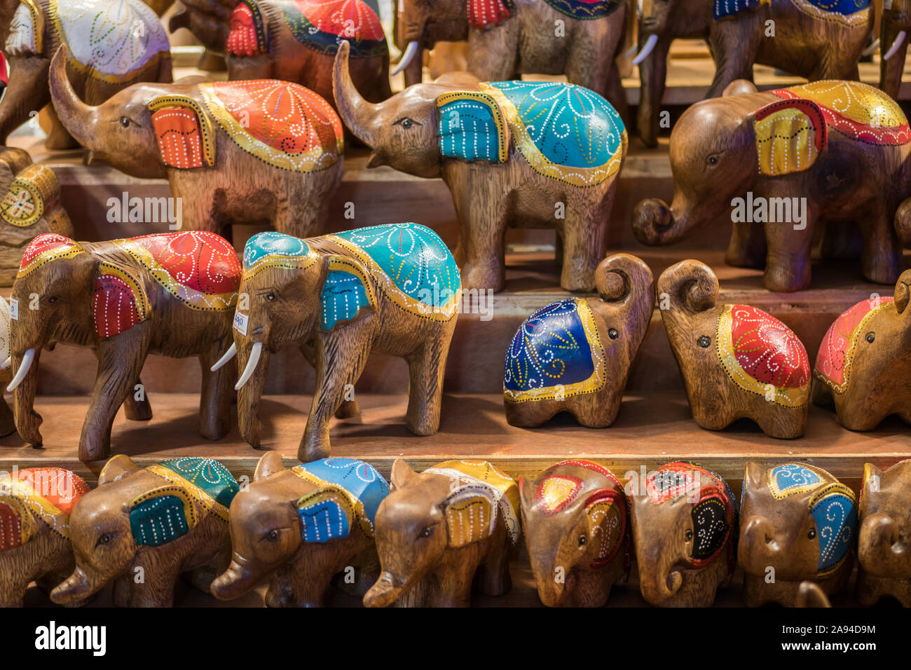 Closeup view of the carved wooden elephants selling in the souvenirs stall at Ratchada Rot Fai