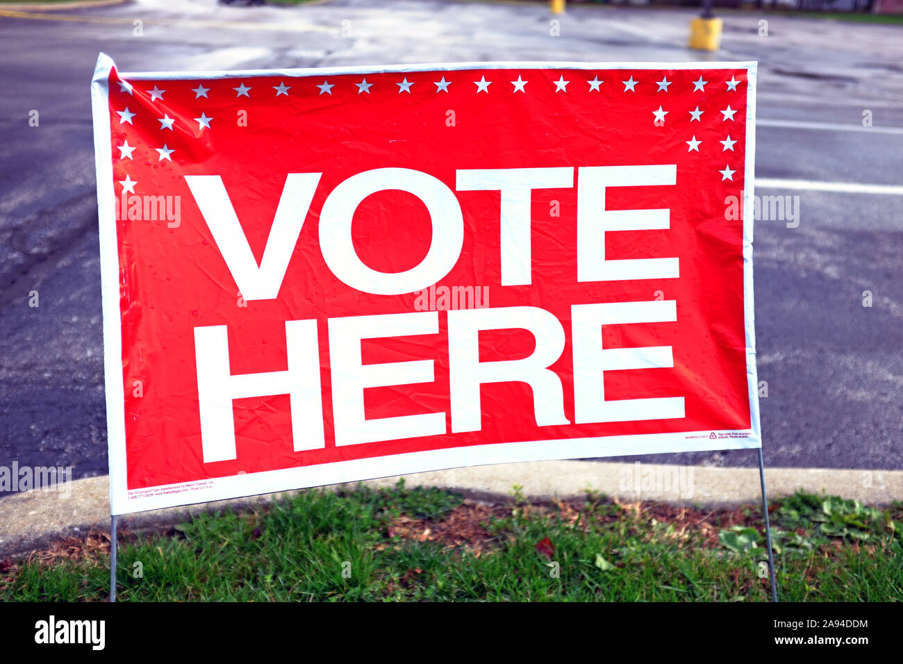 Red and white 'vote here' sign posted during the 2019 November US elections outside a polling station Stock Photo