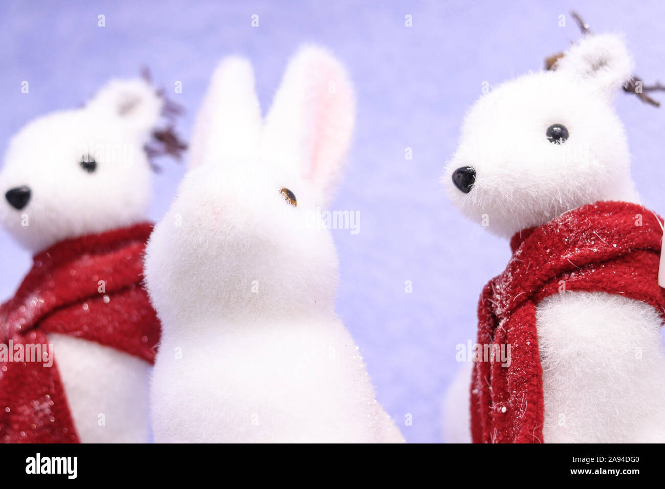Christmas winter holidays home party decoration cute toys fluffy furry animals rabbit and minks in red scarfs in snow Stock Photo