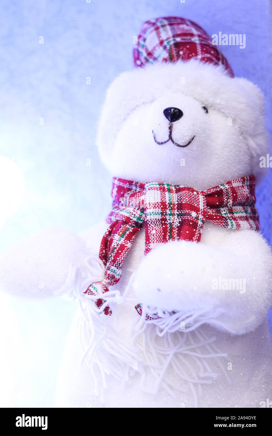 White smiling polar bear toy in a red checkred hat with fur and scarf ...
