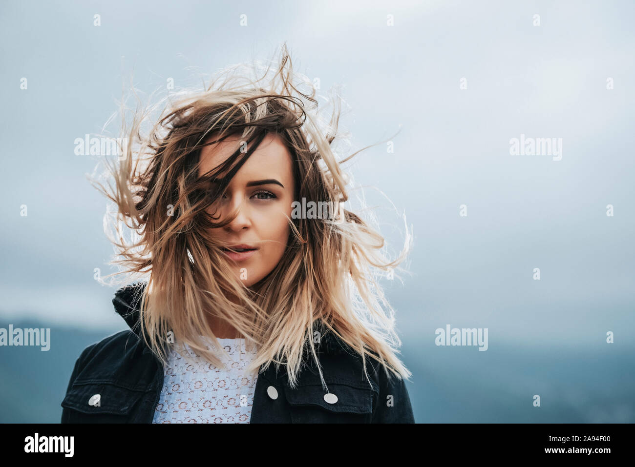 Portrait of a beautiful young woman with windblown hair; Wellington, North Island, New Zealand Stock Photo