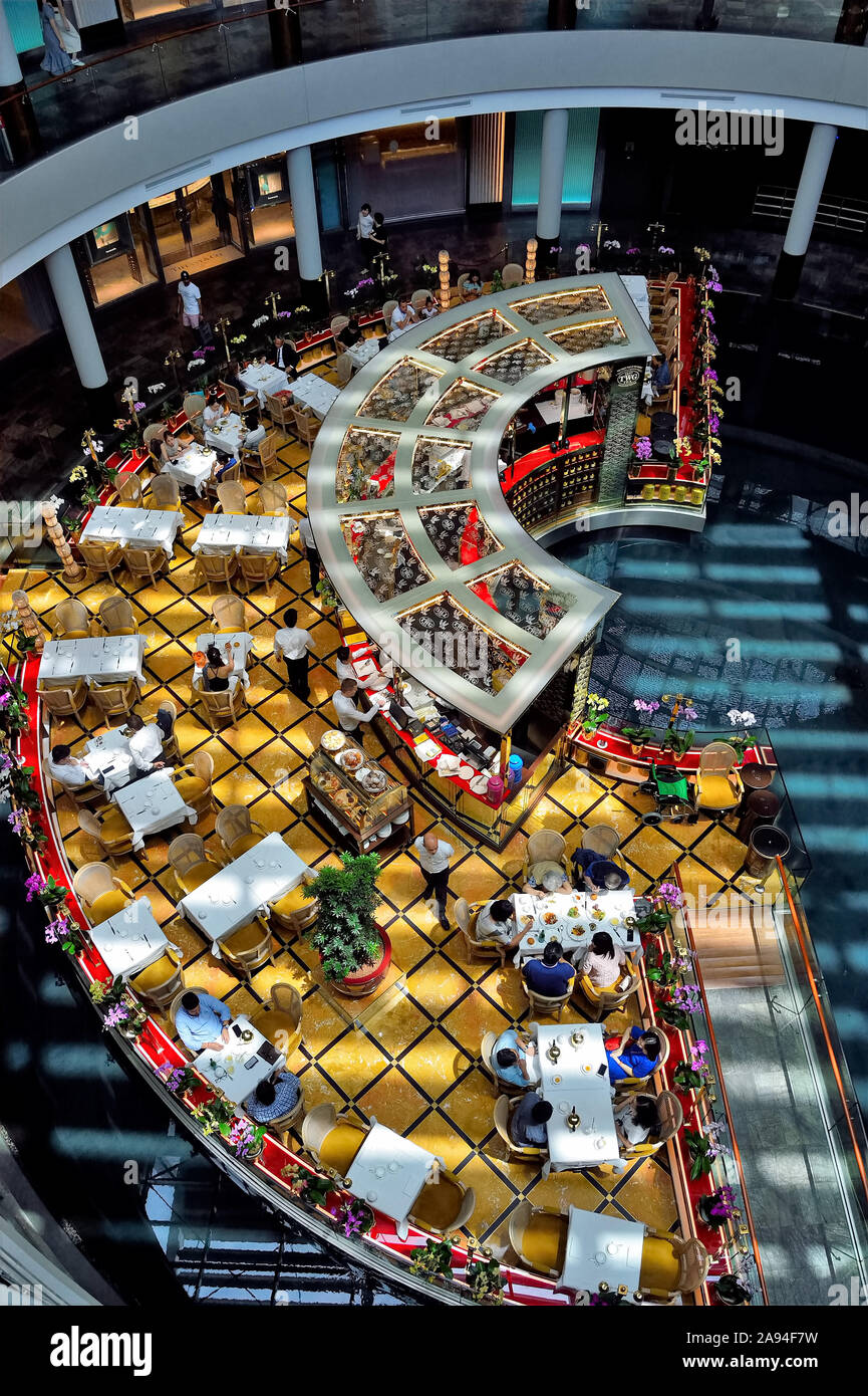 Singapore - September 15 2019: Aerial view of TWG café at Marina Bay Sands shopping centre Singapore with lunchtime customers Stock Photo