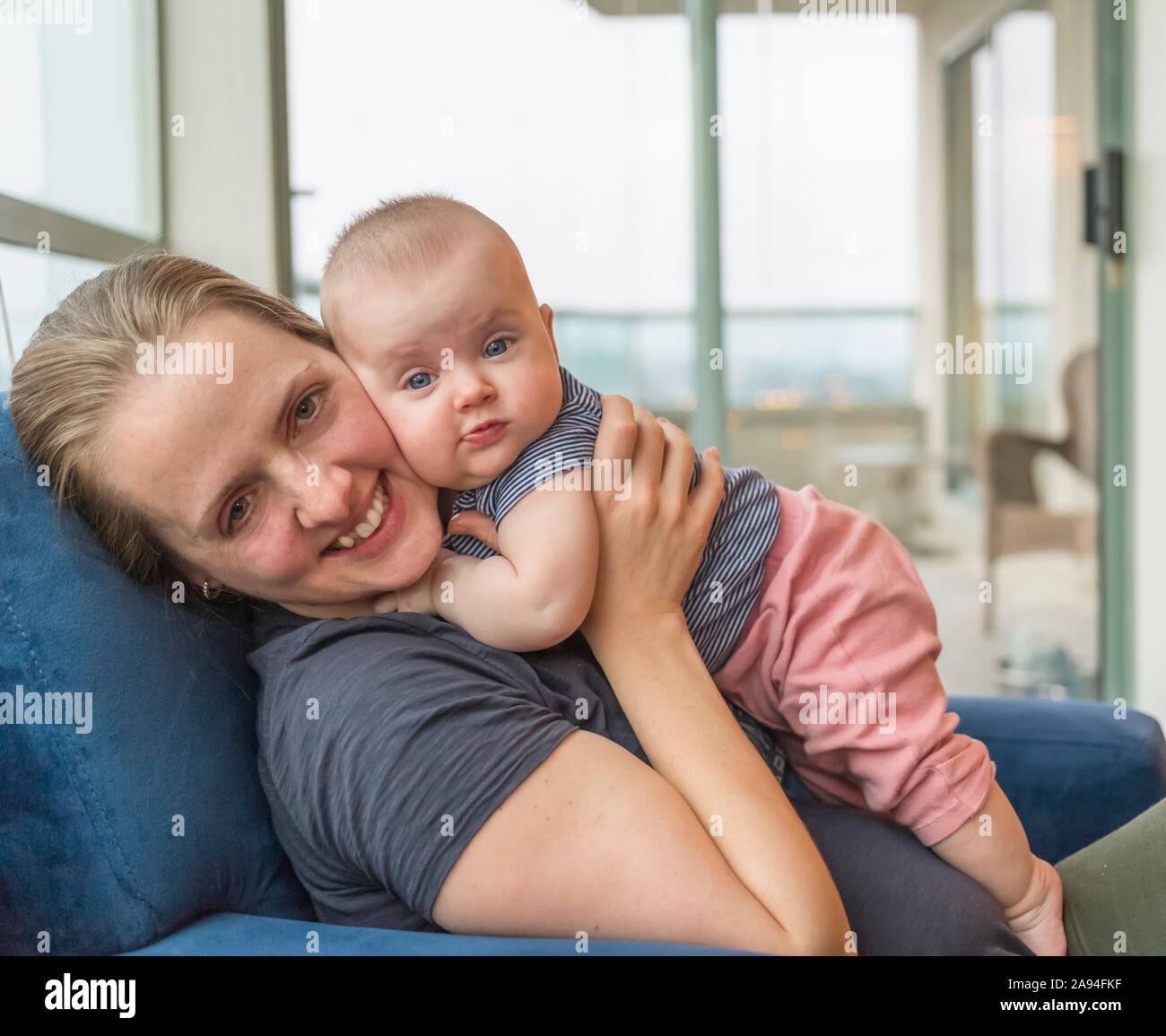 Portrait of infant baby girl with mother at home; Vancouver, British Columbia, Canada Stock Photo
