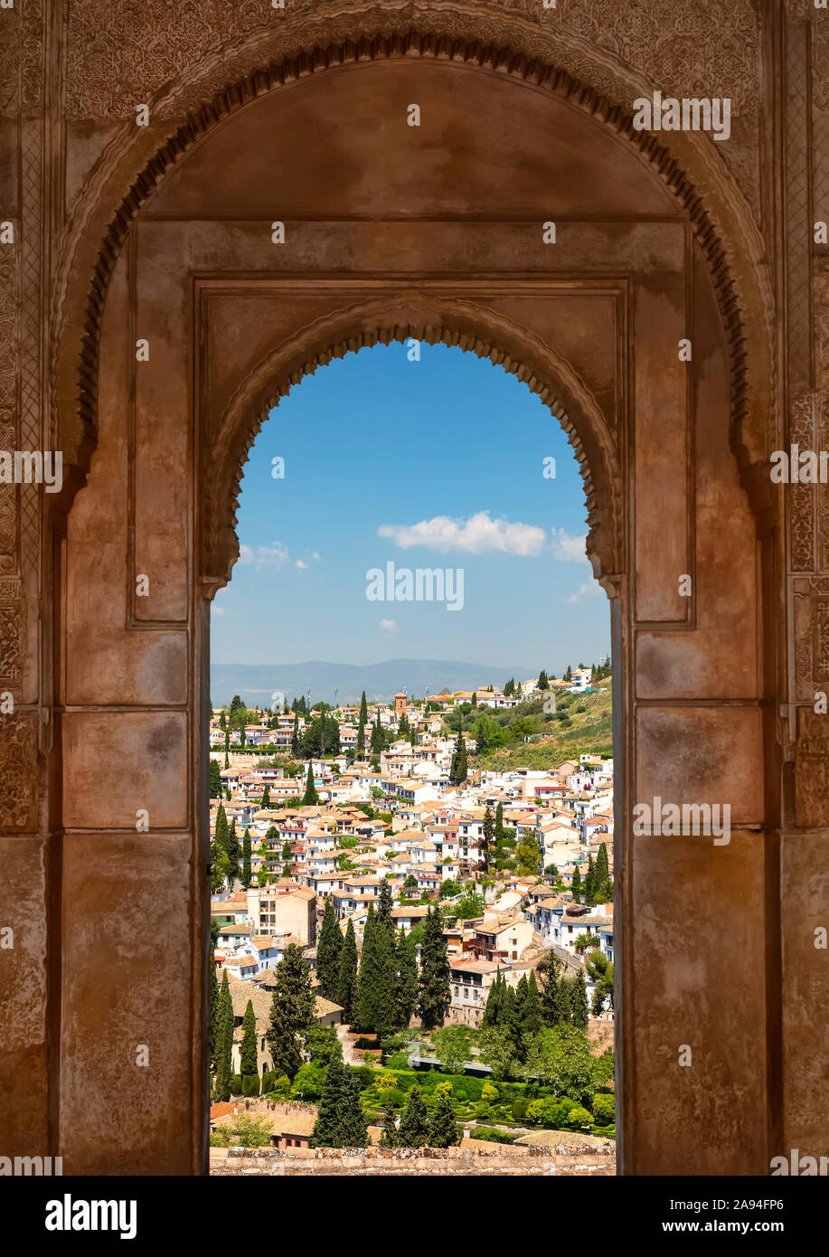 Arched window with a view from Alhambra; Granada, Andalusia, Spain Stock Photo