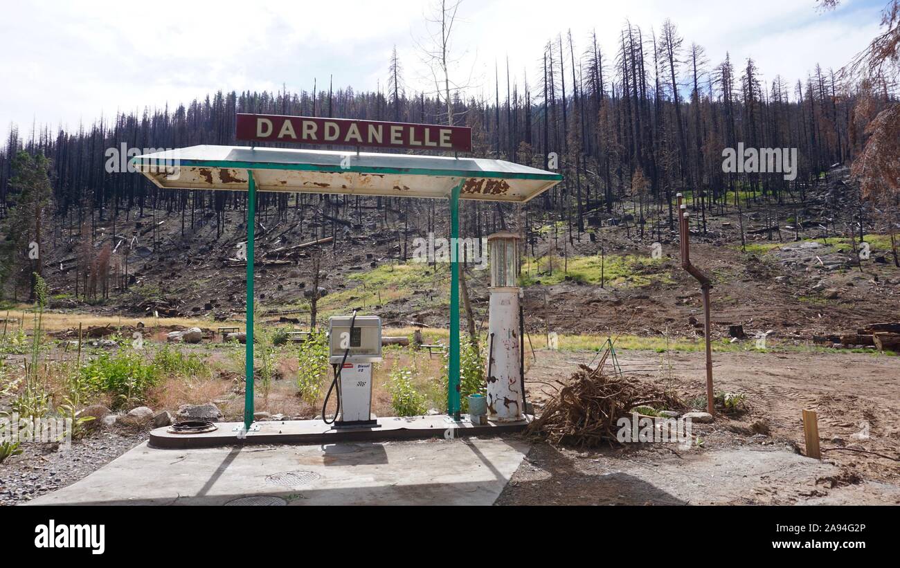 Dardanelle abandoned gas pump, left over from 2018 Donnell Fire. Burnt forest trees in the Stanislaus National Forest on Highway 108, California. Stock Photo
