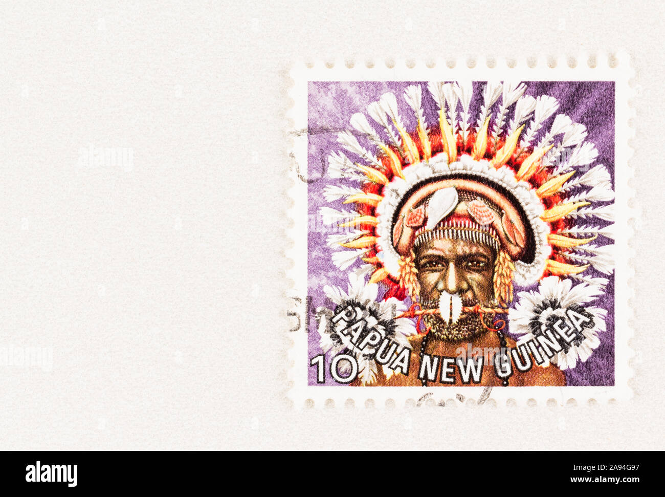 SEATTLE WASHINGTON - October 5, 2019: Papua New Guinea postage stamp with man in traditional headdress with copy space, issue in 1977 Stock Photo