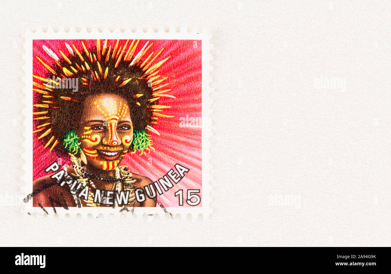 SEATTLE WASHINGTON - October 5, 2019: Papua New Guinea postage stamp with woman in traditional headdress, issue in 1977 Stock Photo