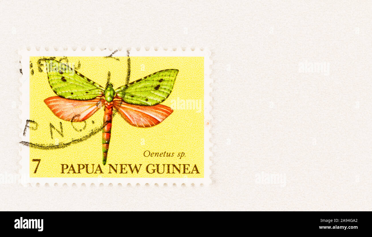 SEATTLE WASHINGTON - October 5, 2019: Papua New Guinea postage stamp featuring flying insect of the Oenetus genus - Aenetus moth.  Scott # 503 Stock Photo