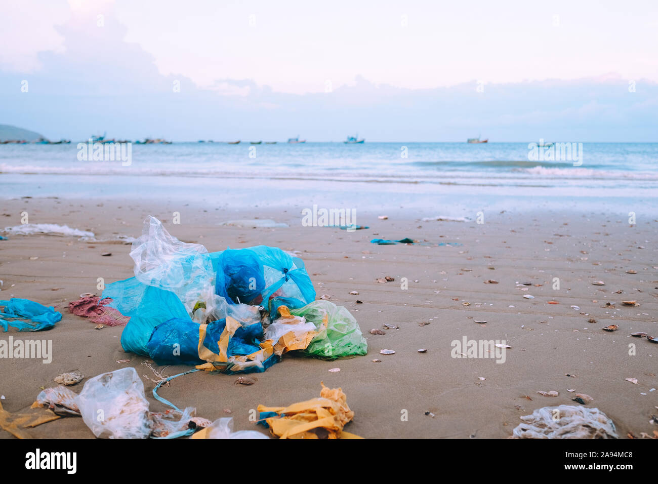 Garbage bags. Blue plastic garbage bags full of trash on the beach