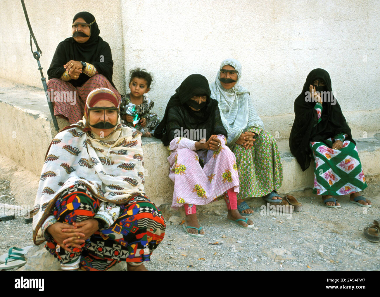 Women and children at a village water tank in the Musandam Peninsula, an Omani enclave in eastern Arabia Stock Photo