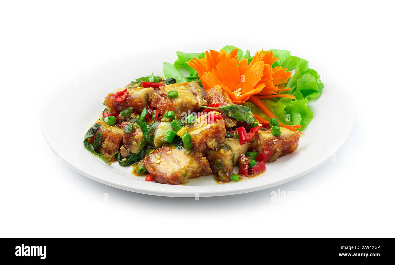 Stire Fried Crispy Pork with Thai Basil,Chilli Pepers (Crispy Belly Pork) Asian Food and Thai Food dish Decorate vegetables and carved carrot side vie Stock Photo