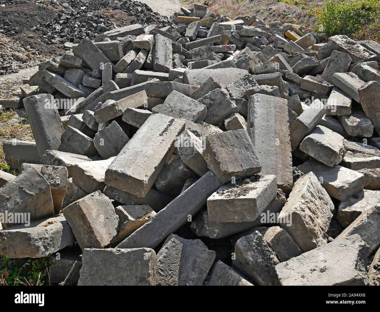Large pile of old broken concrete blocks that were used in road