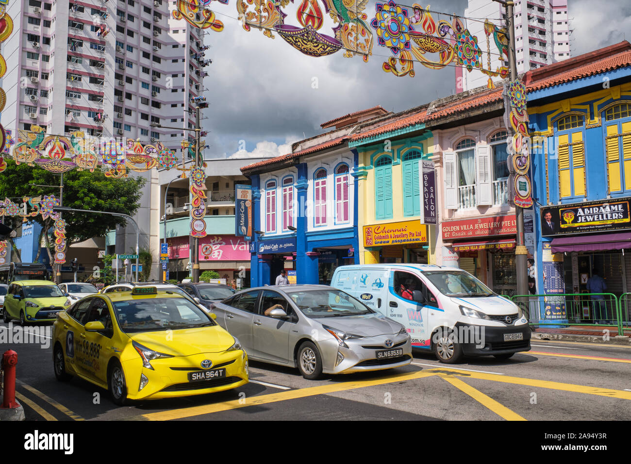 Cars stopping at a pedestrian crossing in colorful Serangoon Road, Little India, an ethnic district dominated by Indians Stock Photo