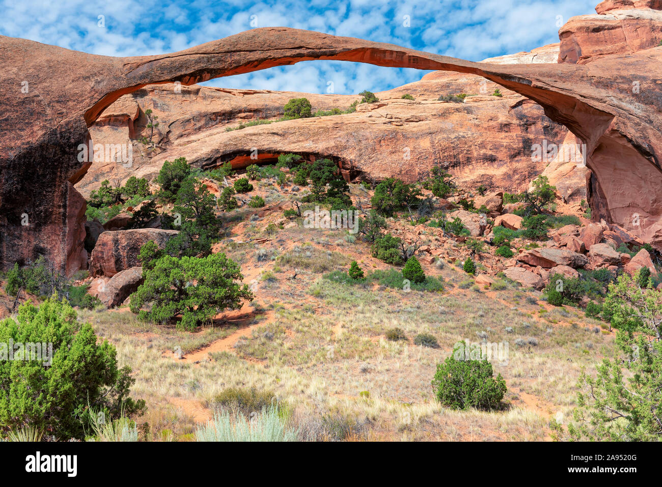 Landscape Arch in red color mountains and blue sky. Arches National Park in Utah, USA. Stock Photo
