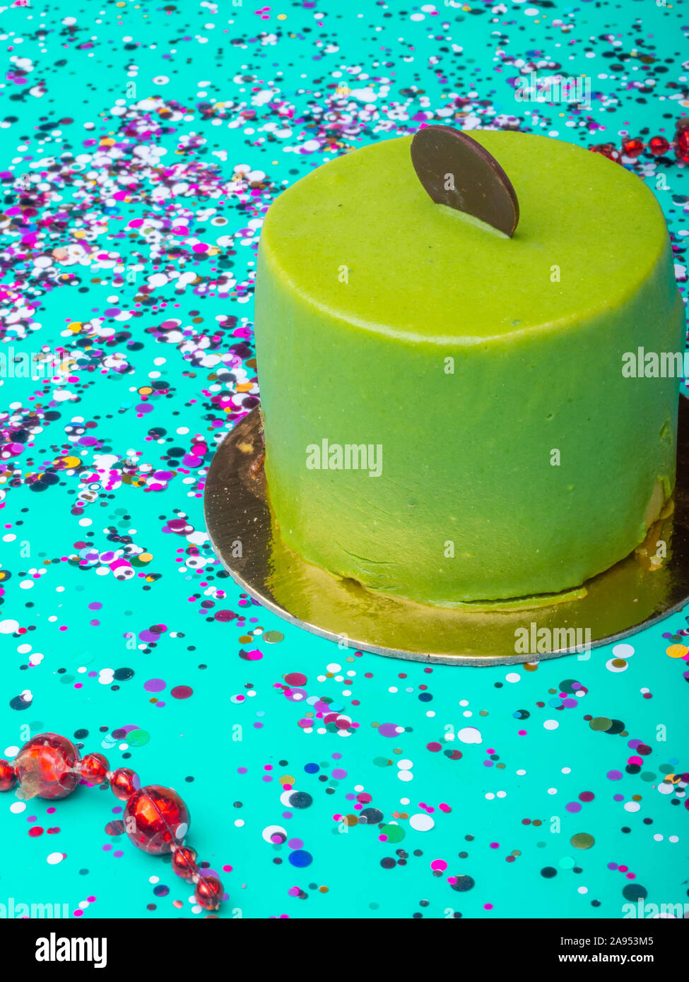 Delicious sweet french lime mouse cakes with green mint glaze, chocolate  slice, Modern desserts on trend color mint background Stock Photo - Alamy