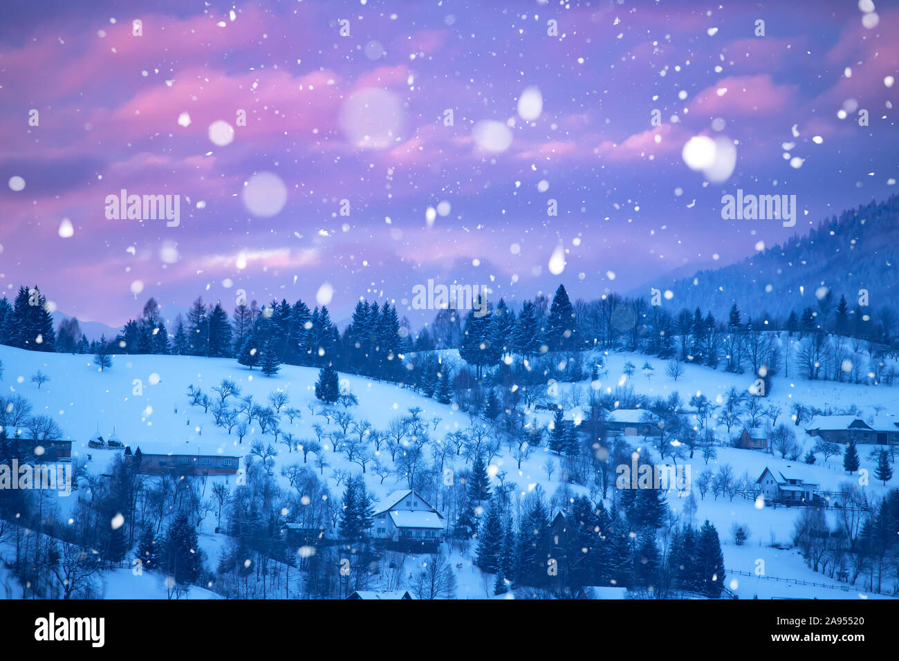 Magic Christmas concept with falling snow over beautiful winter landscape in the sunset. Stock Photo
