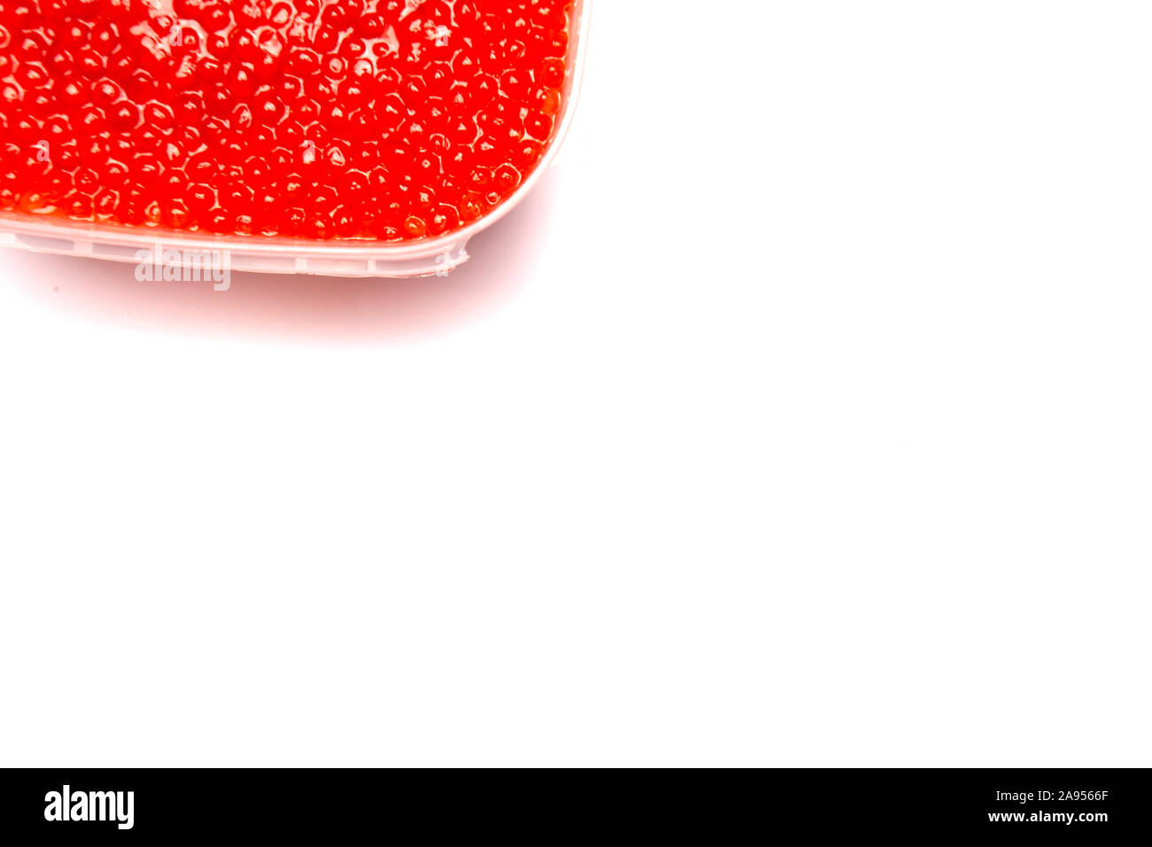 Red caviar in a jar on a white background. Stock Photo