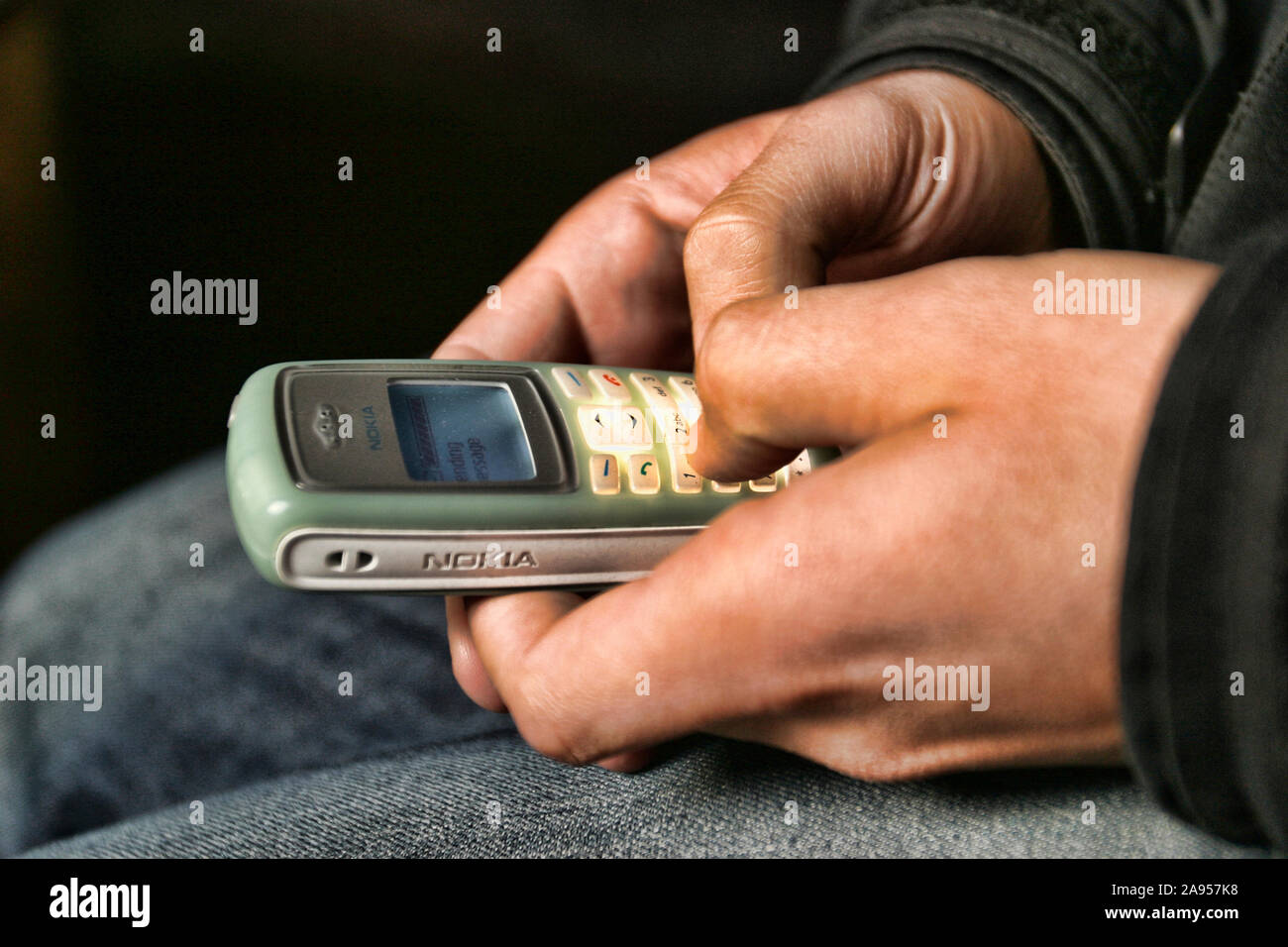 Sending a message with a mobile-phone Stock Photo