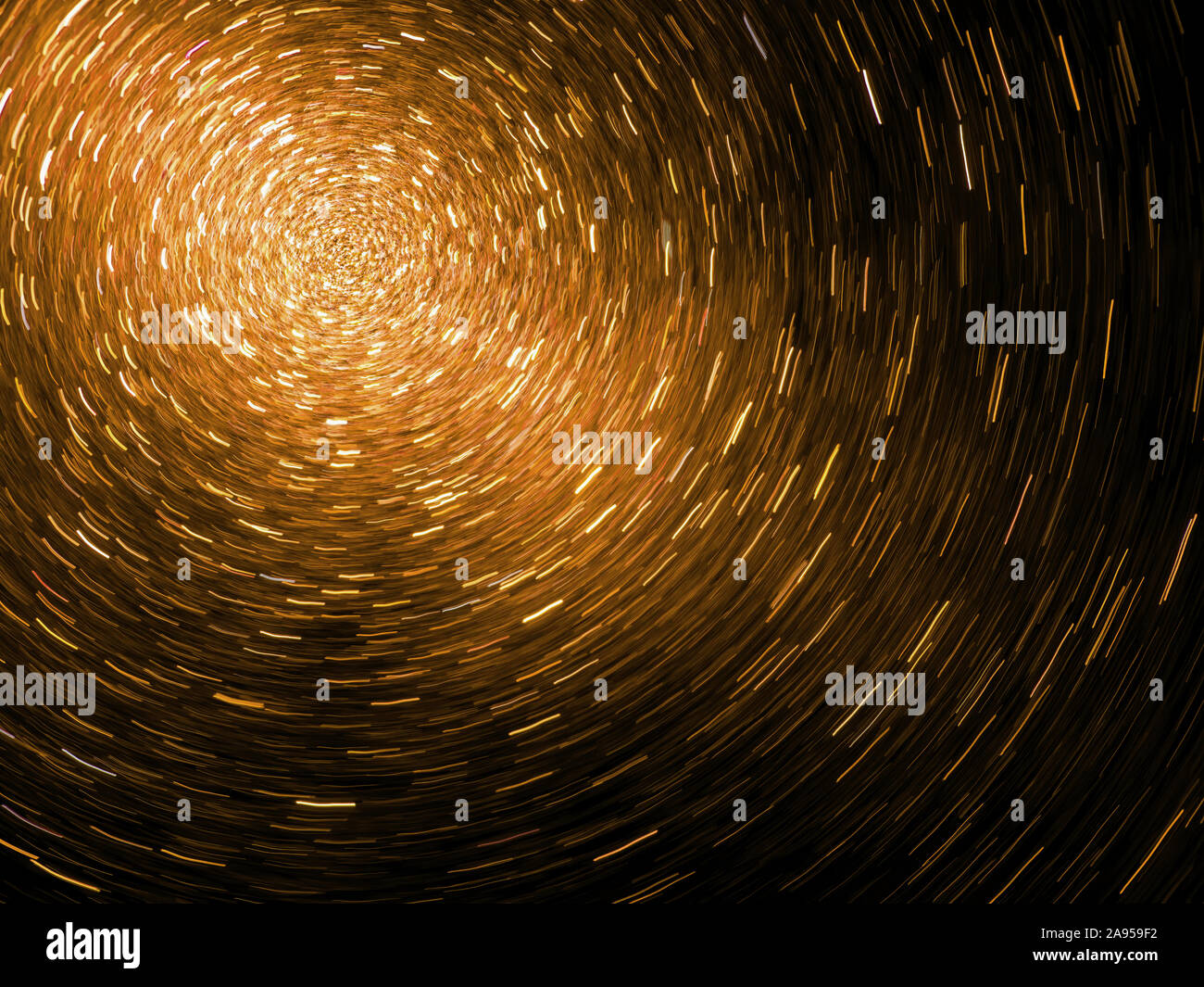 Swiring vortex of light - particles. Science - physics maybe. Dark background. Stock Photo