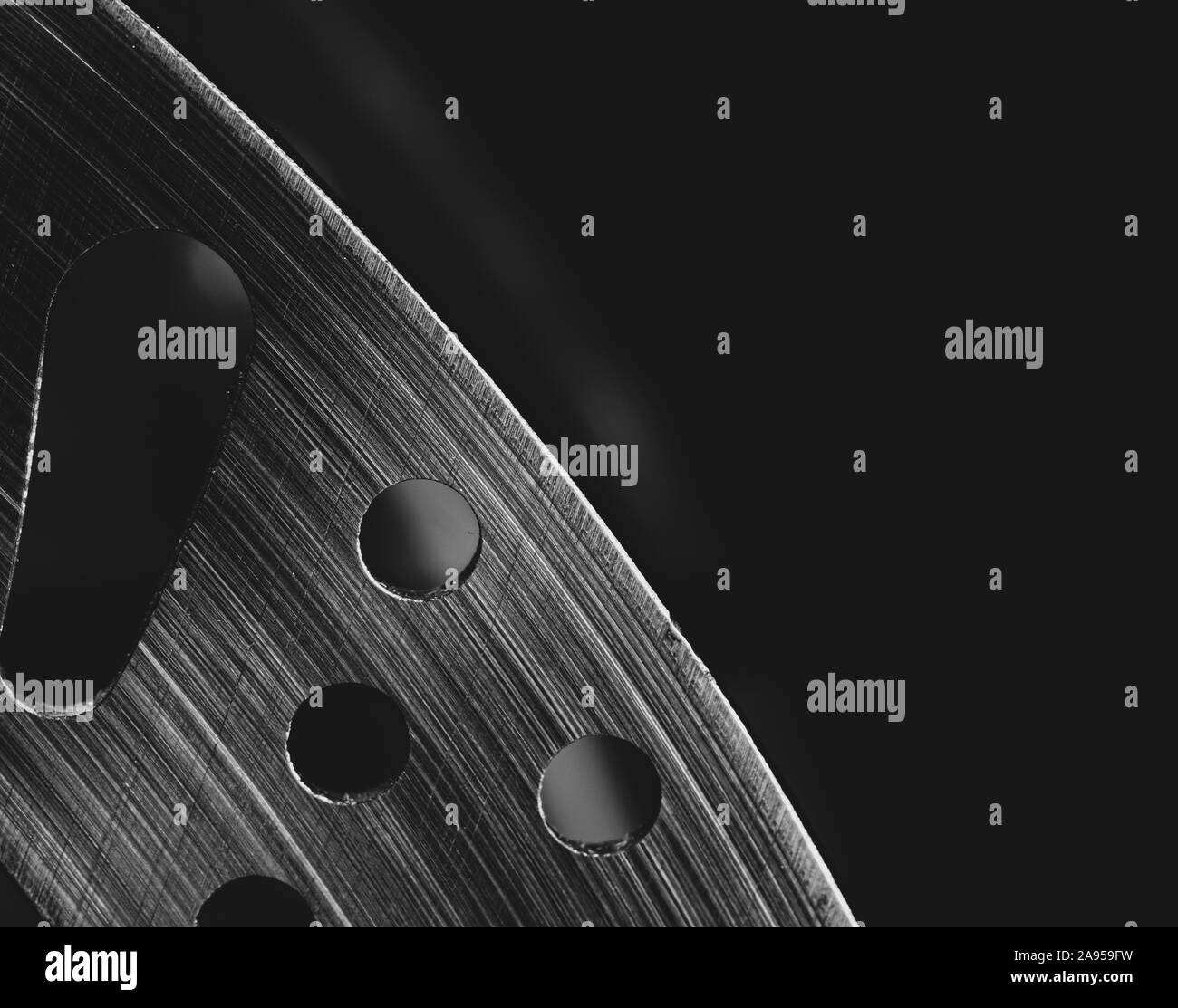 Macro image of a section of a mountain bike disc brake, set against a black background Stock Photo