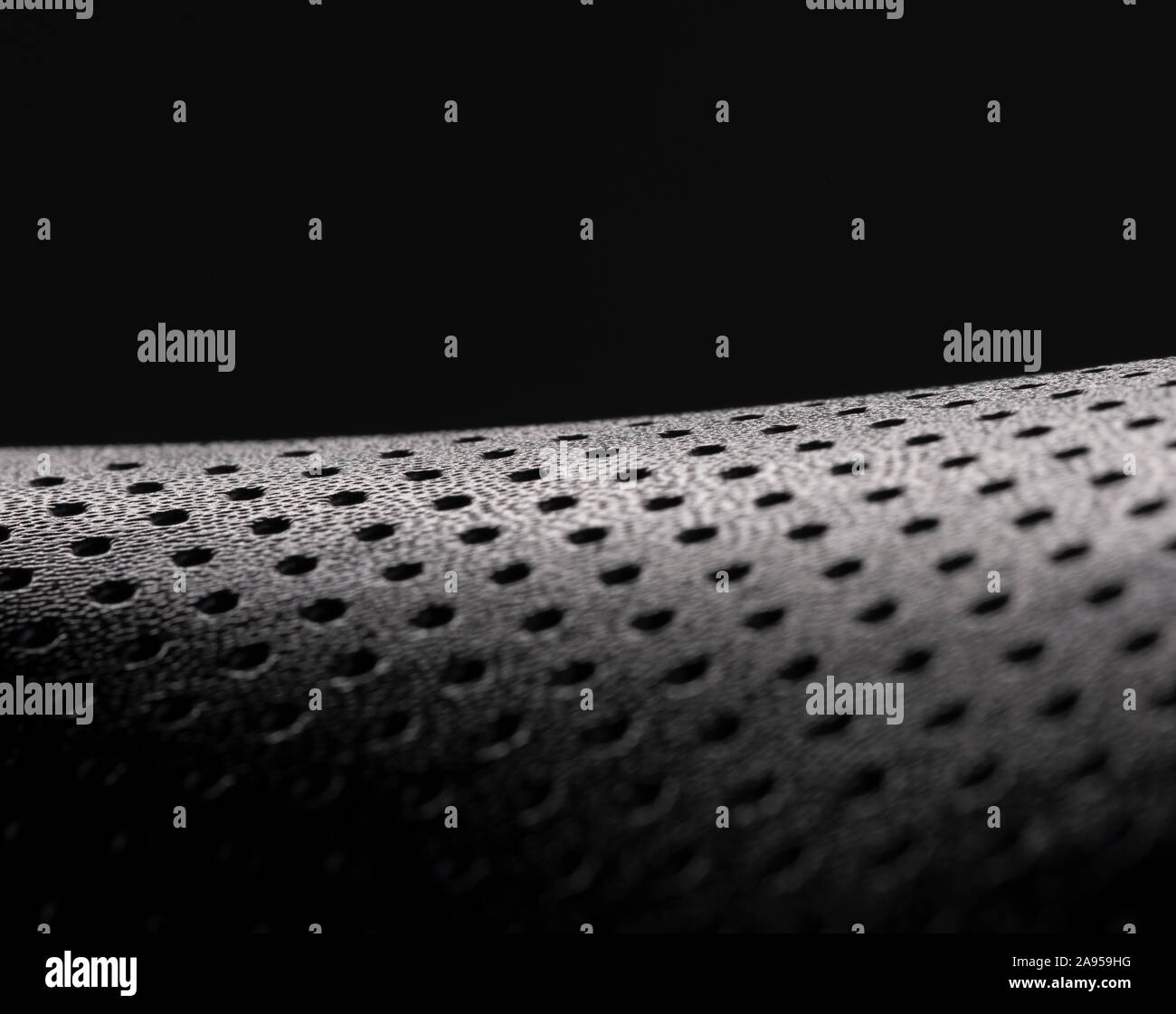 Macro image of the texture of a black bicycle seat against a black background Stock Photo