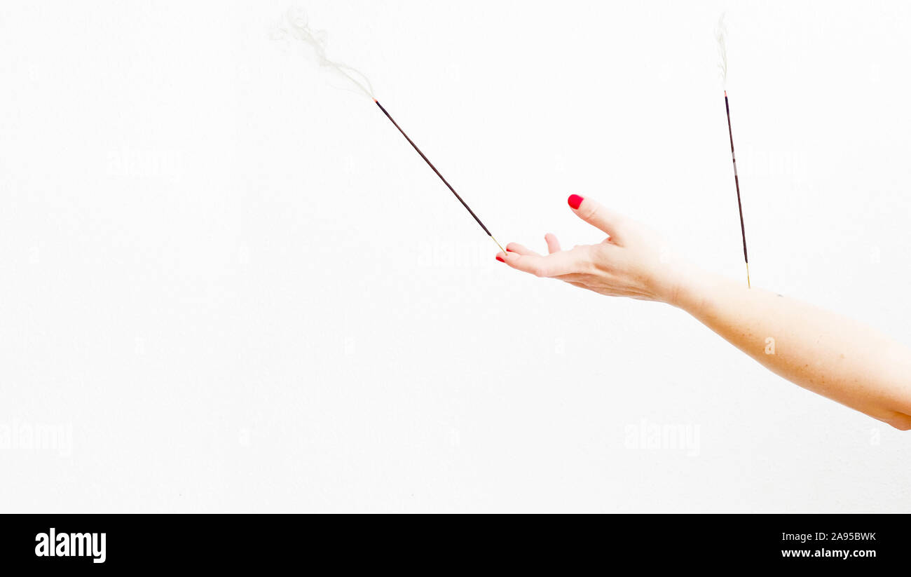 Woman burning incense stick hi-res stock photography and images - Alamy