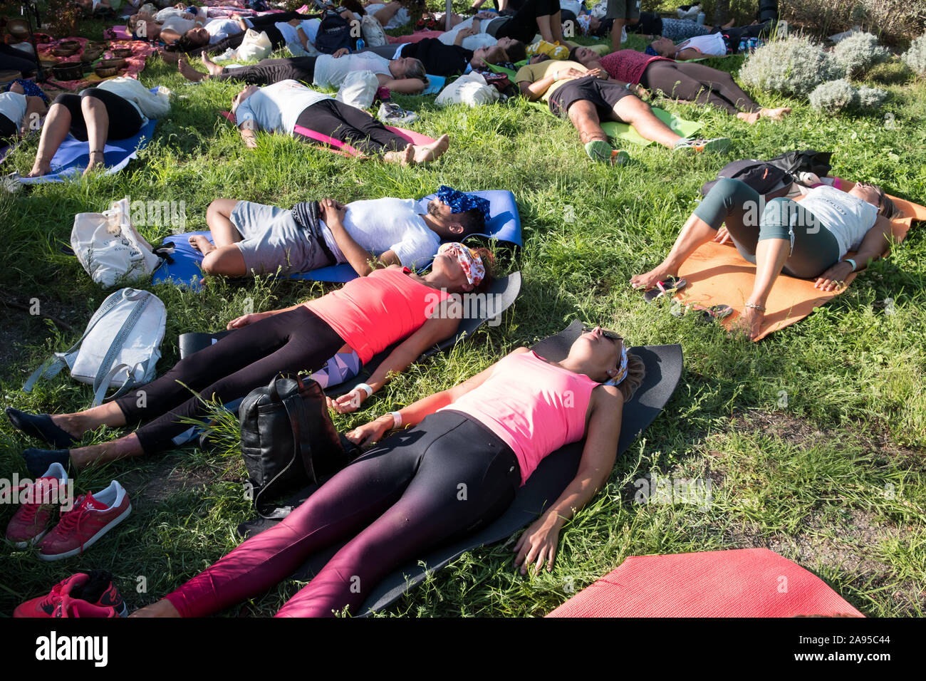Group lying down during a Meditative Sound Journey at the Wanderlust festival, in Lisbon, Portugal. Stock Photo