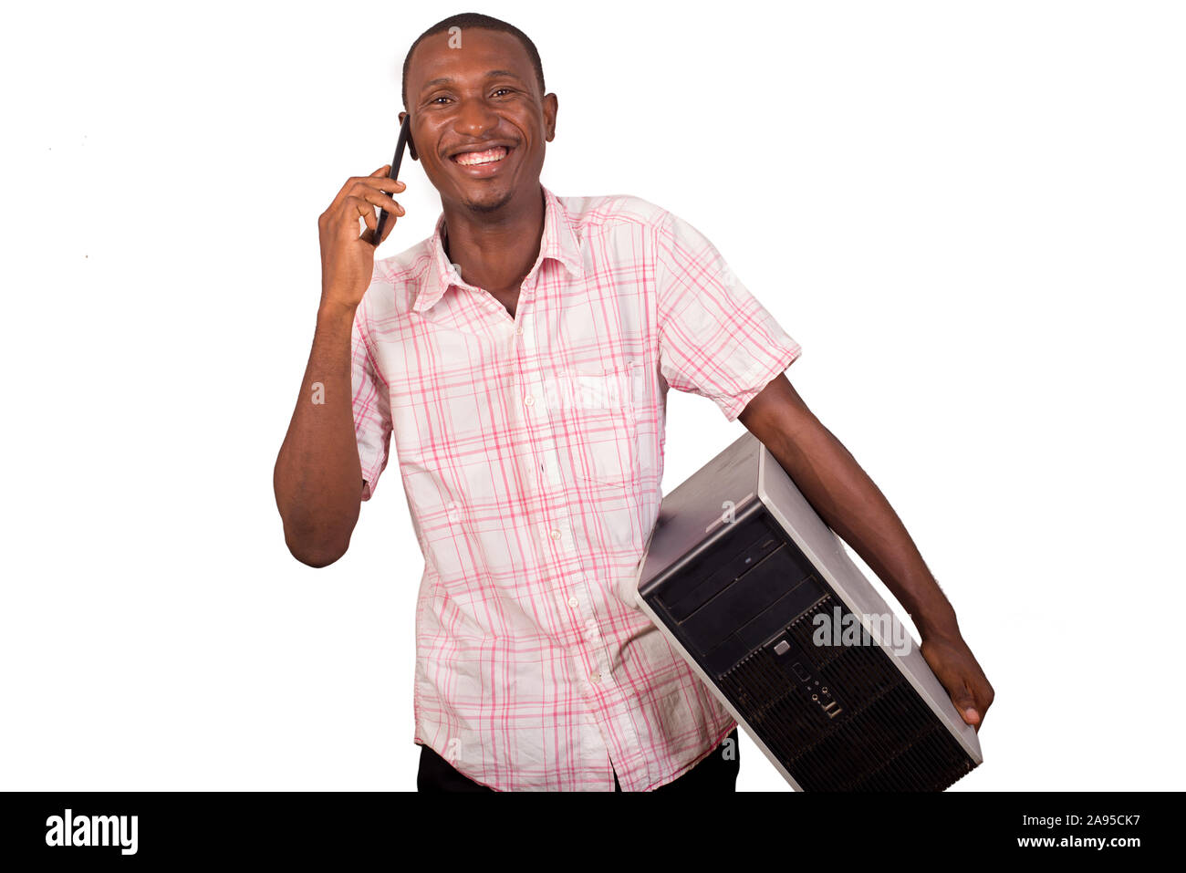 young technician with computer in hands and talking on the phone Stock Photo