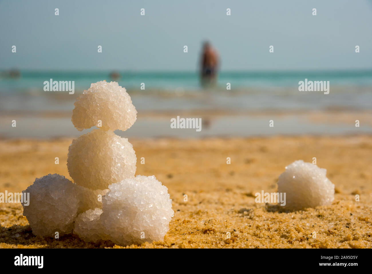 Relax balls of salt on the sand. Sky horizon. Sea. Sand. Dead Sea. Stock Photo