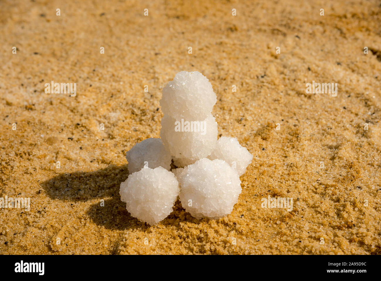 Relax balls of salt on the sand. Sky horizon. Sea. Sand. Dead Sea. Stock Photo