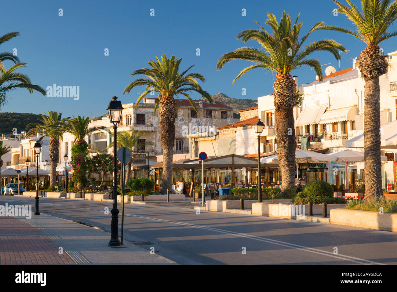 Rethymno, Crete, Greece. View along the palm-lined seafront promenade, sunrise. Stock Photo