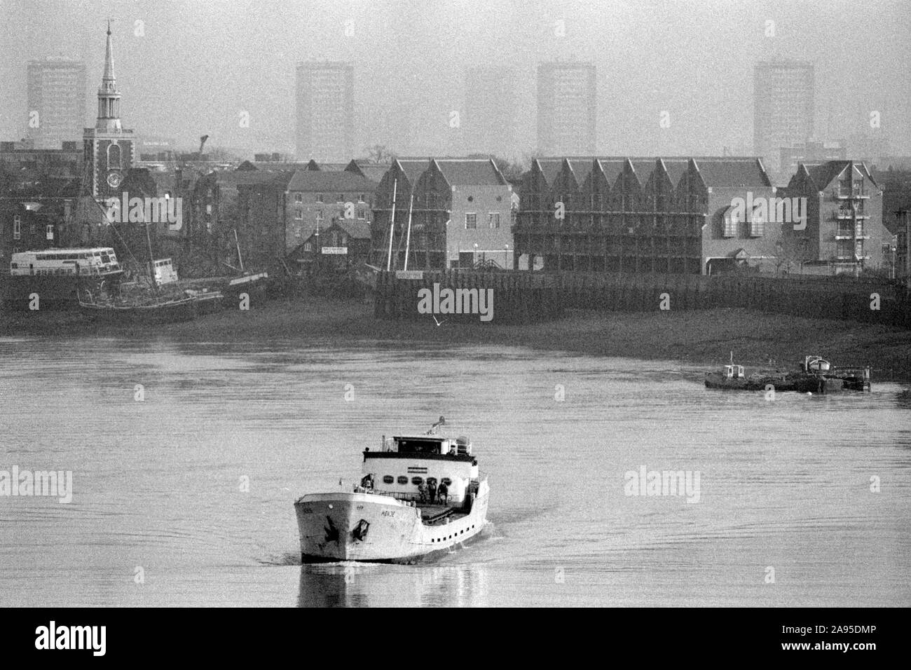 London Docklands Development 1980s UK. View across River Thames towards Rotherhithe, St Mary's Church new flats being built.1987 England. HOMER SYKES. Stock Photo