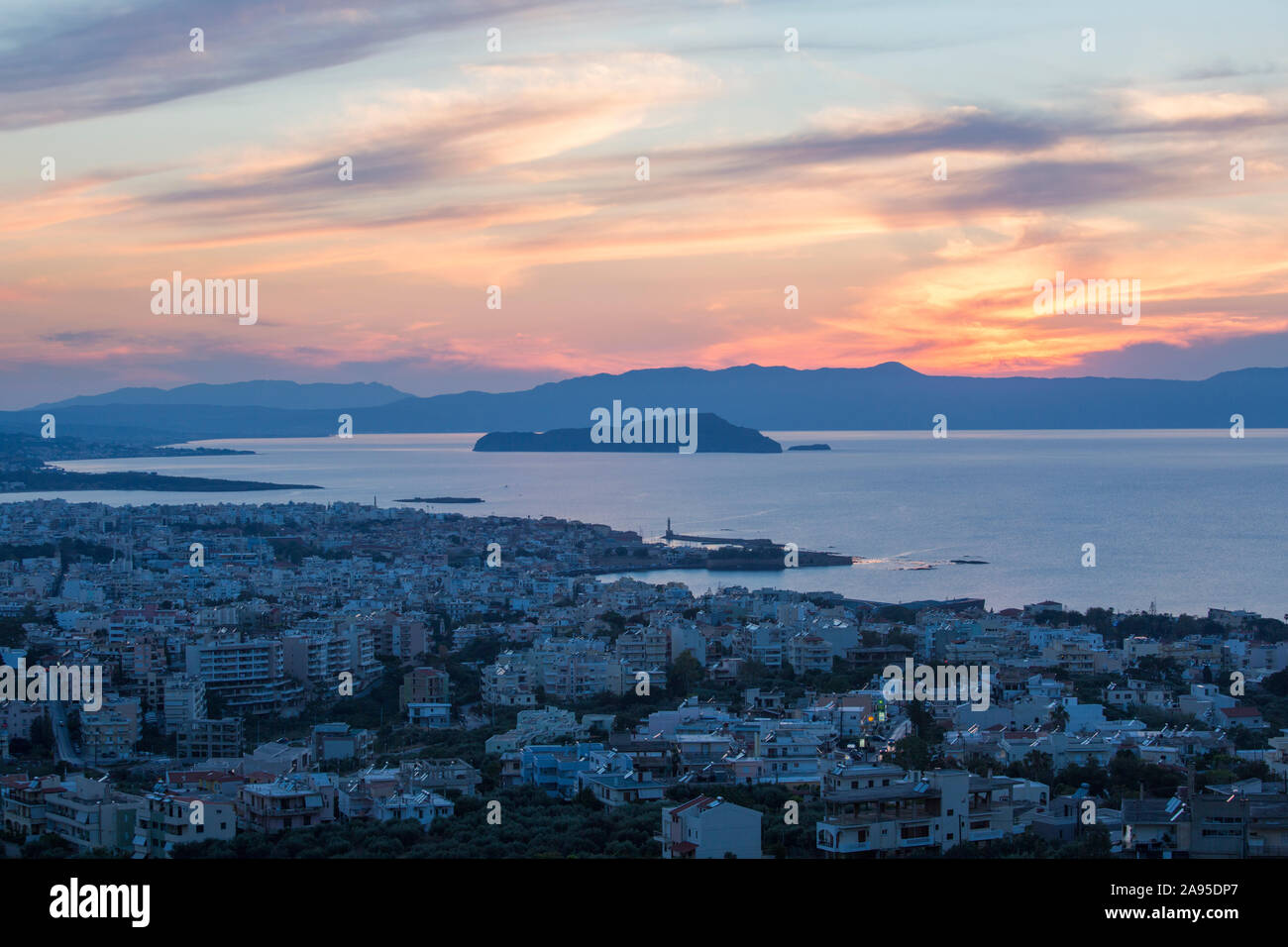 Chania, Crete, Greece. View over the city and Gulf of Chania at sunset, the island of Agii Theodori prominent. Stock Photo
