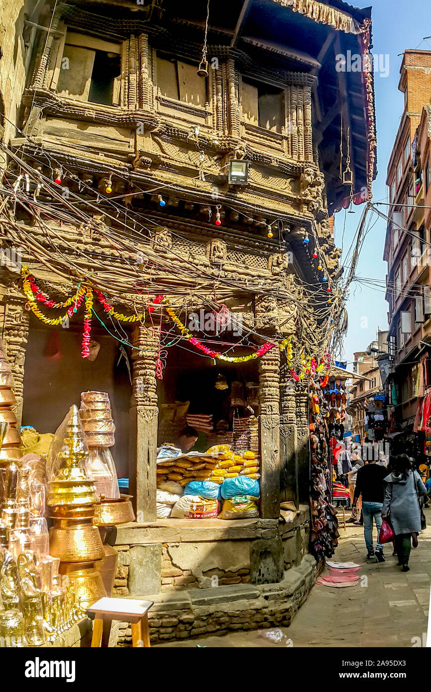 A vendor selling household wares and food stuff  in an old building at a corner of the old section of Thamel district in Kathmandu, Nepal Stock Photo
