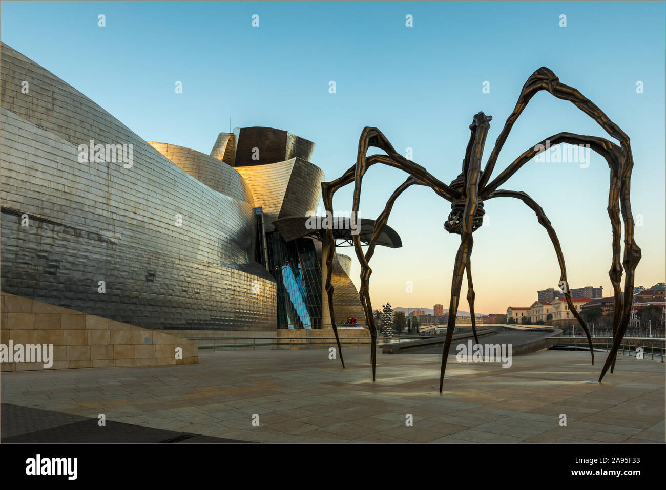 Maman spider sculpture by artist Louise Bourgeois outside the Guggenheim Museum at sunrise, Nervión River, Bilbao, Basque Country, Spain Stock Photo